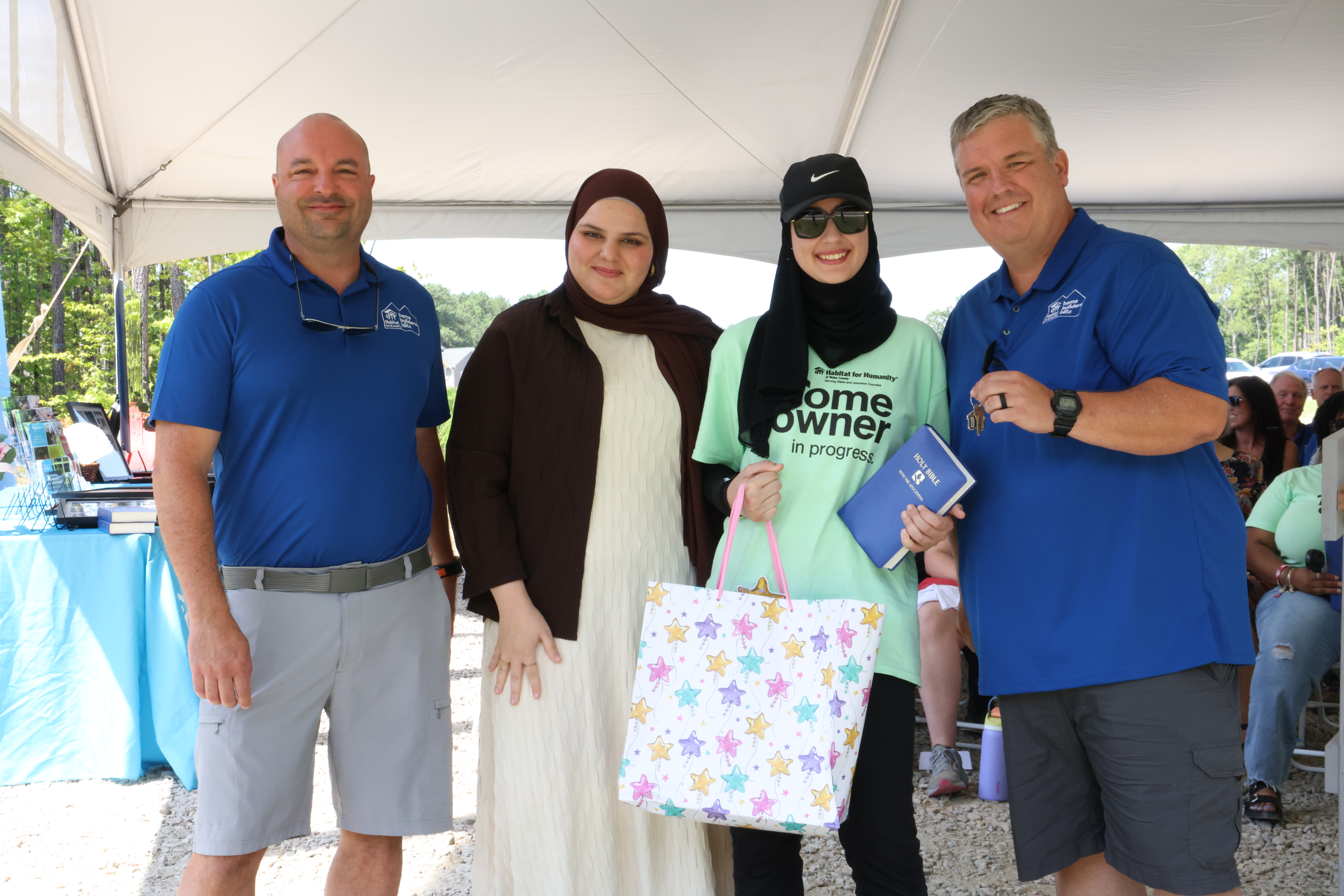 Homeowners presented with a Quran and prayer mat
