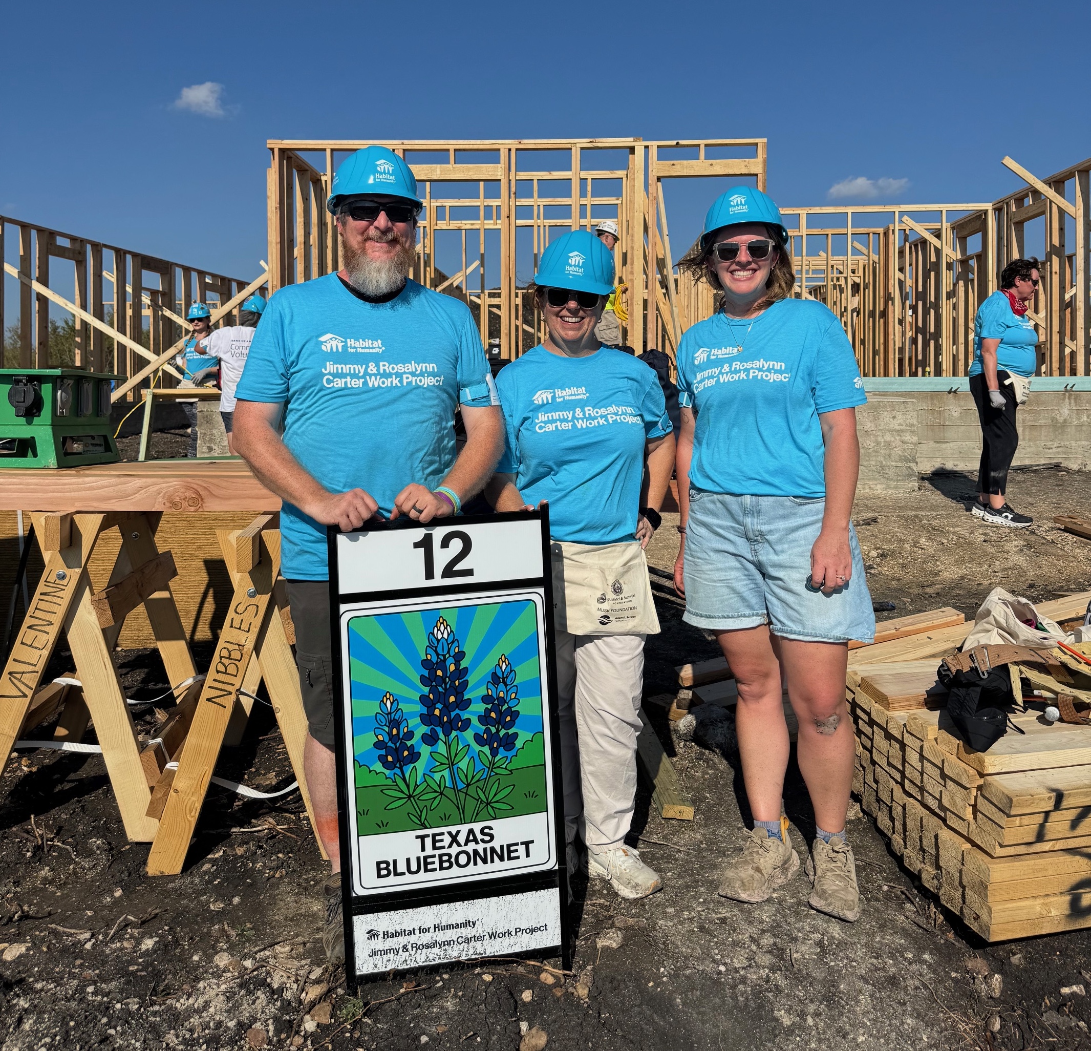 Habitat Wake CEO joins with VP of construction and director of construction and land development at the 2025 Jimmy Carter work project