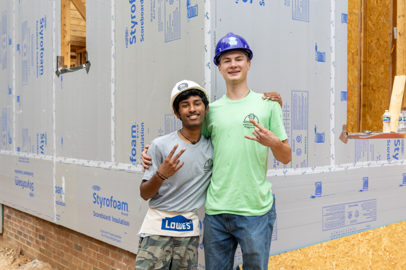 two summer of service interns on habitat build site in wendell